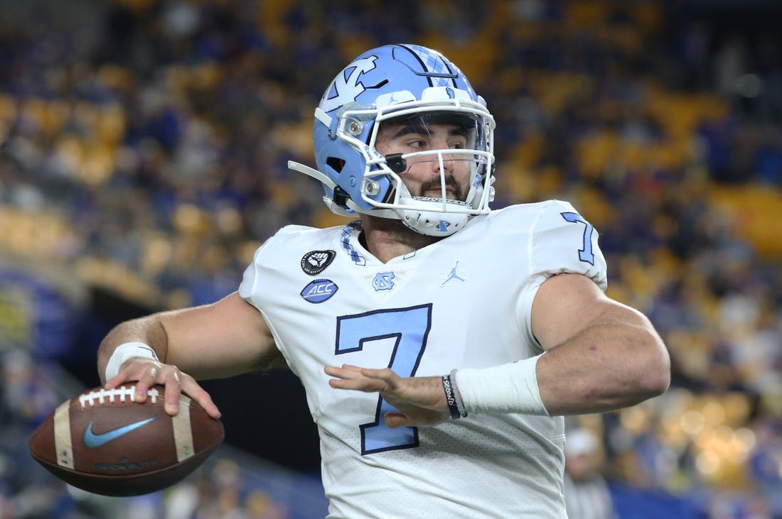 Nov 11, 2021; Pittsburgh, Pennsylvania, USA;  North Carolina Tar Heels quarterback Sam Howell (7) warms up on the sidelines against the Pittsburgh Panthers during the first quarter at Heinz Field. Mandatory Credit: Charles LeClaire-USA TODAY Sports