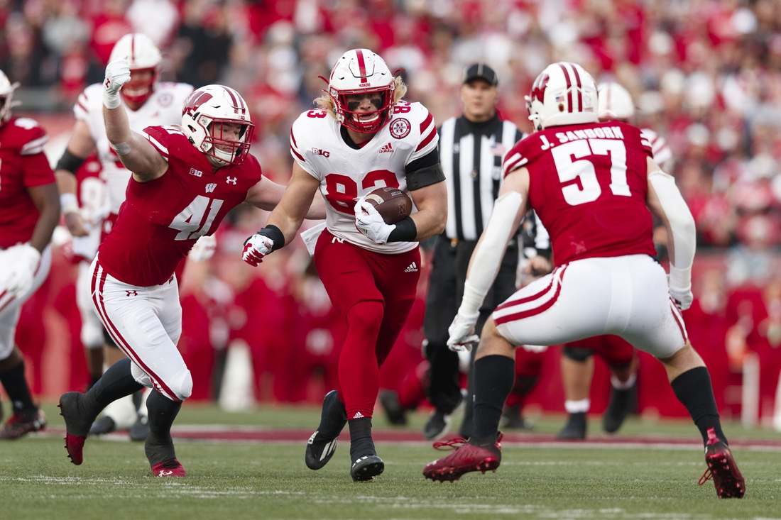 Nov 20, 2021; Madison, Wisconsin, USA;  Nebraska Cornhuskers tight end Travis Vokolek (83) rushes with the football between Wisconsin Badgers linebackers Noah Burks (41) and Jack Sanborn (57) during the first quarter at Camp Randall Stadium. Mandatory Credit: Jeff Hanisch-USA TODAY Sports