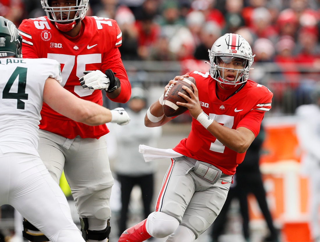 Ohio State Buckeyes quarterback C.J. Stroud (7) scrambles out of the pocket during the third quarter of the NCAA football game against the Michigan State Spartans at Ohio Stadium in Columbus on Saturday, Nov. 20, 2021.

Michigan State Spartans At Ohio State Buckeyes Football