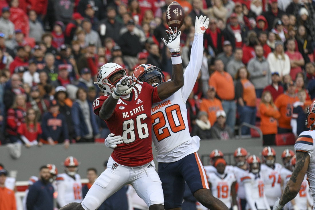 Nov 20, 2021; Raleigh, North Carolina, USA; North Carolina State Wolfpack wide receiver Emeka Emezie (86) goes up for a pass against Syracuse Orange defensive back Darian Chestnut (20) during the first half at Carter-Finley Stadium. Mandatory Credit: William Howard-USA TODAY Sports