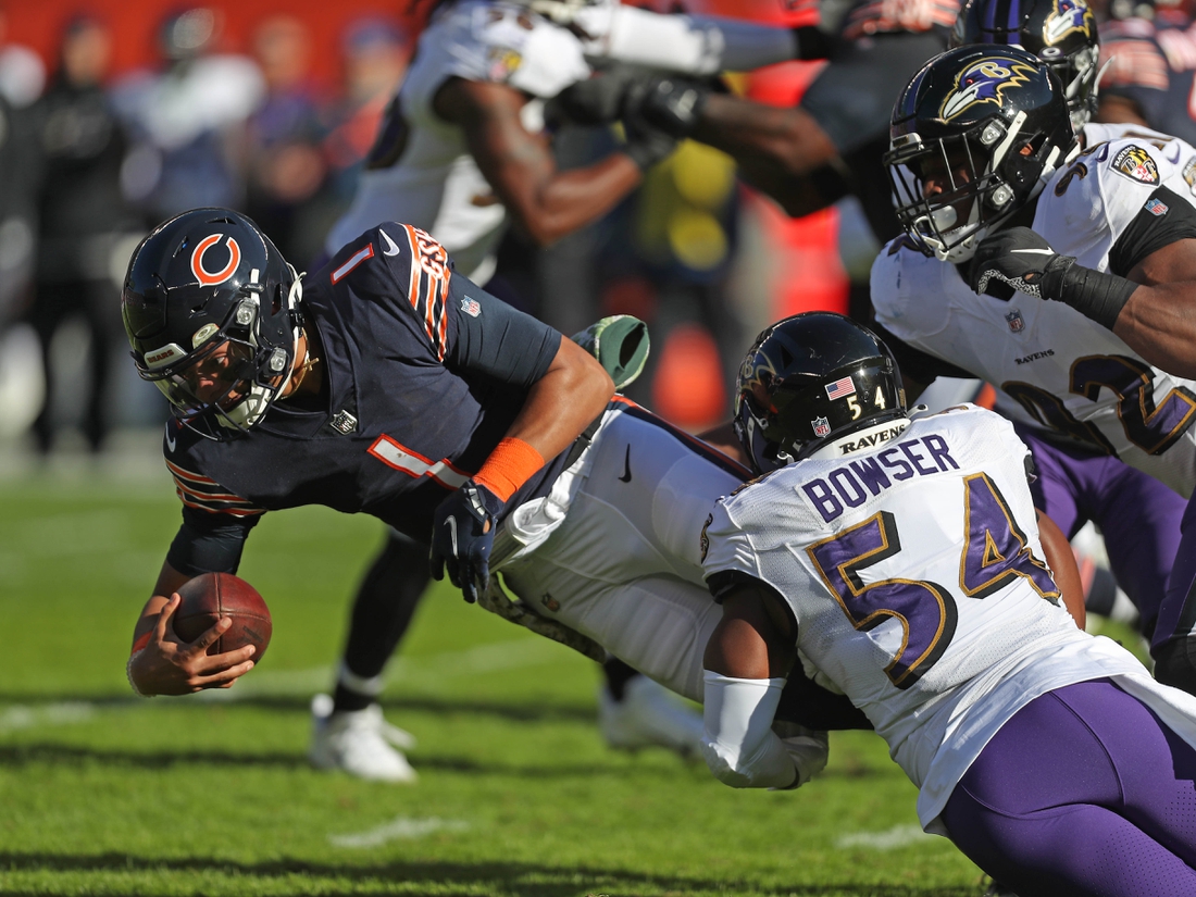 Nov 21, 2021; Chicago, Illinois, USA; Chicago Bears quarterback Justin Fields (1) is tackled by Baltimore Ravens outside linebacker Tyus Bowser (54) during the first quarter at Soldier Field. Mandatory Credit: Dennis Wierzbicki-USA TODAY Sports