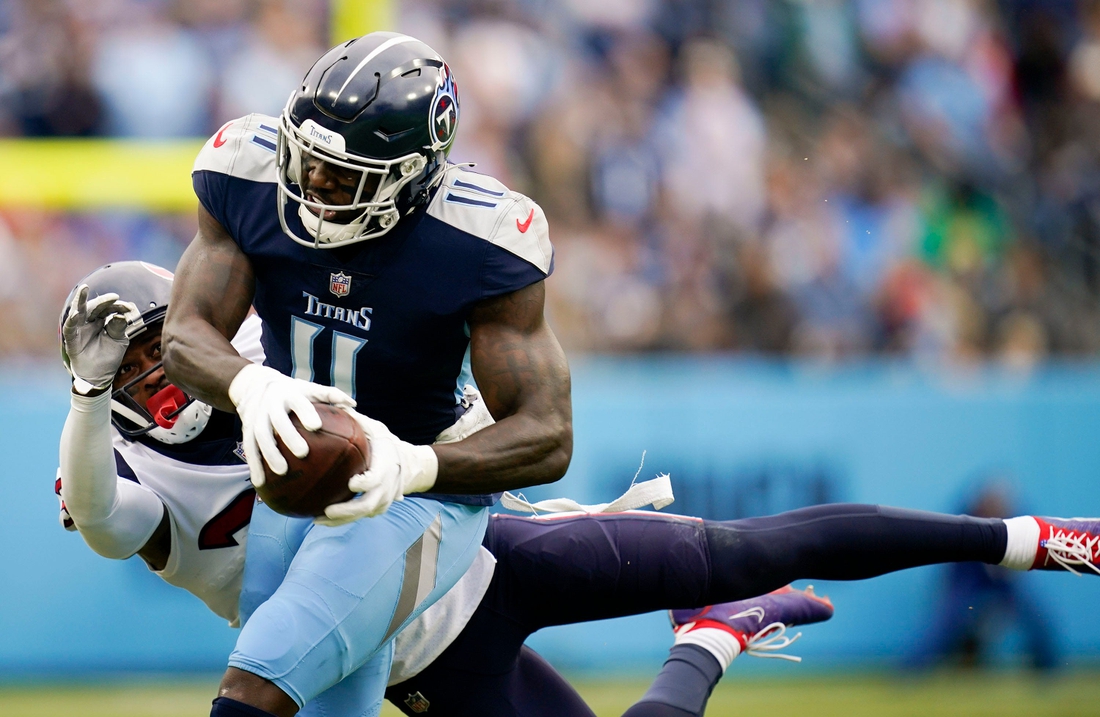 Tennessee Titans wide receiver A.J. Brown (11) pulls in a catch under pressure from Houston Texans cornerback Terrance Mitchell (39) during the first quarter at Nissan Stadium Sunday, Nov. 21, 2021 in Nashville, Tenn.Titans Texans 2196