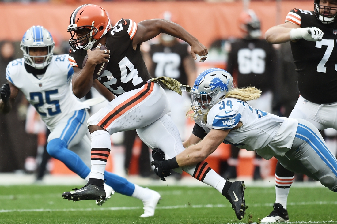 Nov 21, 2021; Cleveland, Ohio, USA; Cleveland Browns running back Nick Chubb (24) runs with the ball as Detroit Lions inside linebacker Alex Anzalone (34) goes for the tackle during the first half at FirstEnergy Stadium. Mandatory Credit: Ken Blaze-USA TODAY Sports