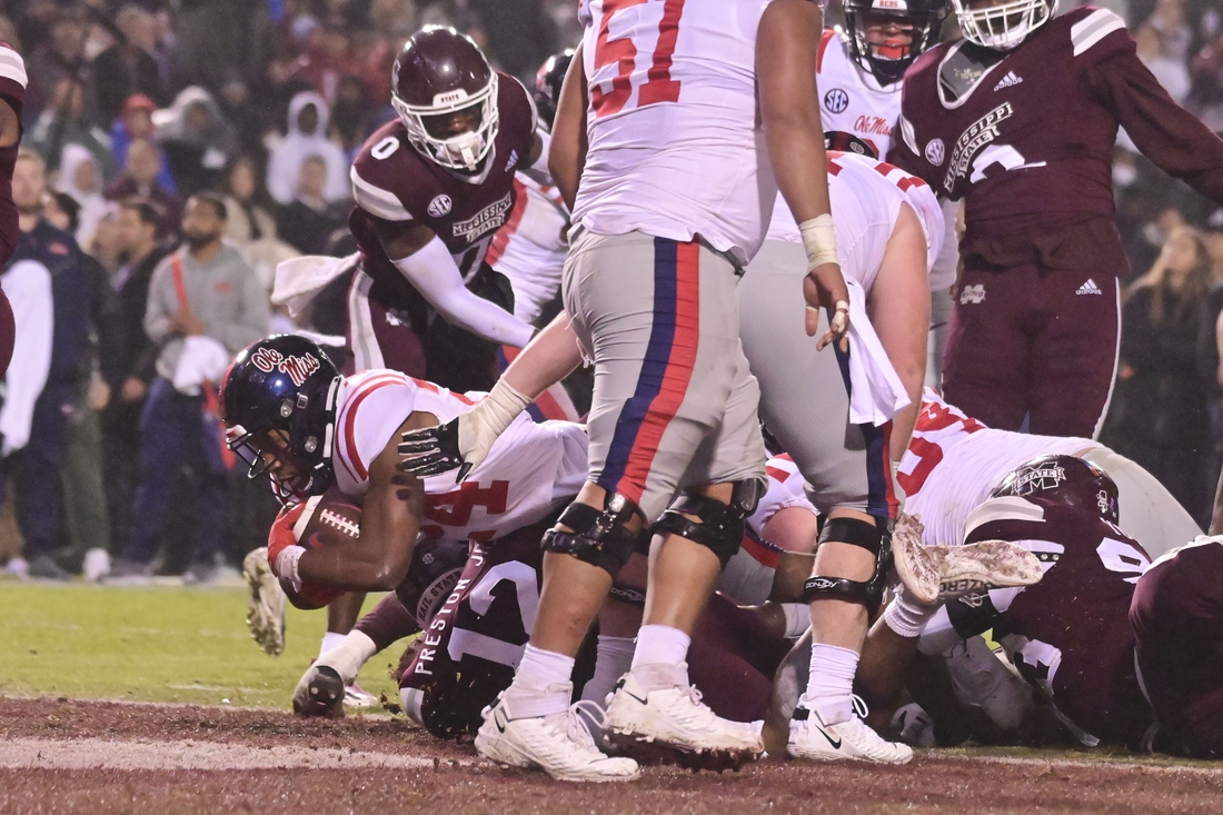 Nov 25, 2021; Starkville, Mississippi, USA; Mississippi Rebels running back Snoop Conner (24) dives into the endzone against the Mississippi State Bulldogs during the second quarter at Davis Wade Stadium at Scott Field. Mandatory Credit: Matt Bush-USA TODAY Sports