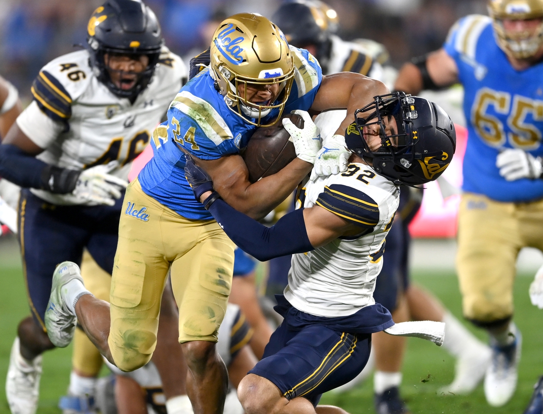 Nov 27, 2021; Pasadena, California, USA;  UCLA Bruins running back Zach Charbonnet (24) rushes to the 9 yard line before he is stopped by California Golden Bears safety Daniel Scott (32) in the second quarter of the game at the Rose Bowl. Mandatory Credit: Jayne Kamin-Oncea-USA TODAY Sports