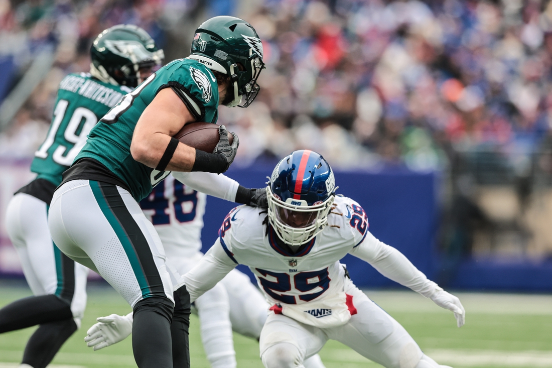 Nov 28, 2021; East Rutherford, New Jersey, USA; Philadelphia Eagles punter Arryn Siposs (8) is tackled by New York Giants free safety Xavier McKinney (29) during the first half at MetLife Stadium. Mandatory Credit: Vincent Carchietta-USA TODAY Sports