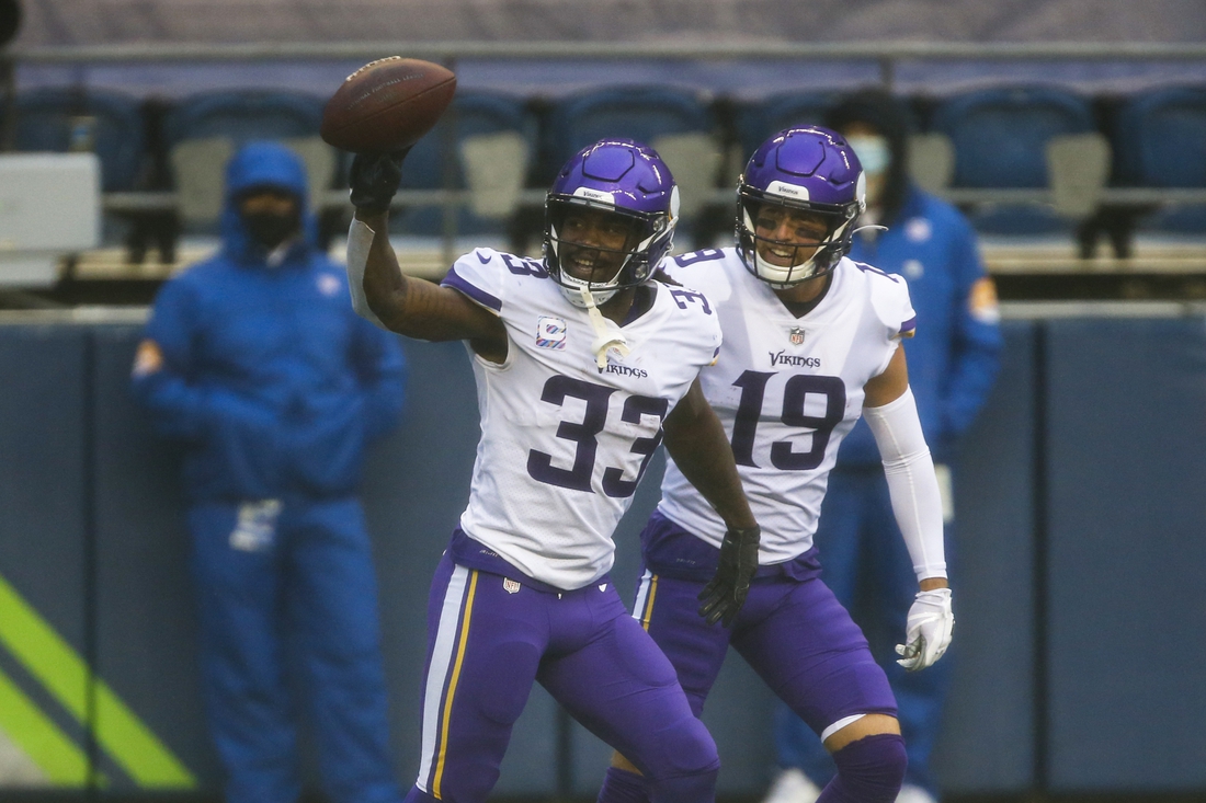 Oct 11, 2020; Seattle, Washington, USA; Minnesota Vikings running back Dalvin Cook (33) celebrates with wide receiver Adam Thielen (19) after rushing for a touchdown against the Seattle Seahawks during the first quarter at CenturyLink Field. Mandatory Credit: Joe Nicholson-USA TODAY Sports