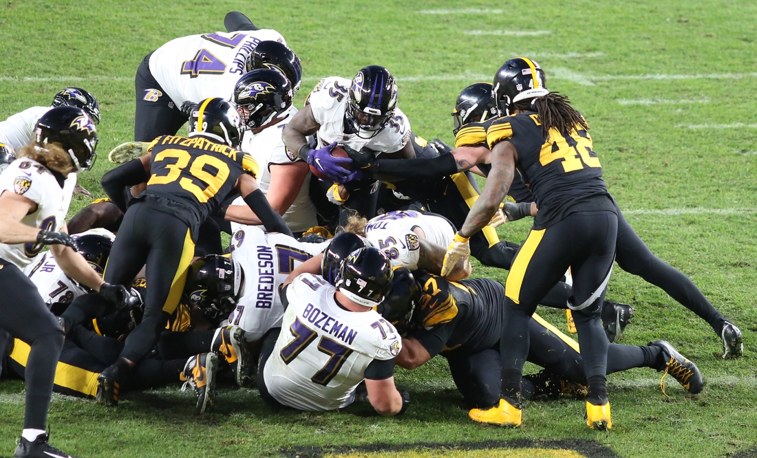 Dec 2, 2020; Pittsburgh, Pennsylvania, USA;  Baltimore Ravens running back Gus Edwards (35) is stopped from crossing the goal line by the Pittsburgh Steelers including free safety Minkah Fitzpatrick (39) and outside linebacker Bud Dupree (48) during the second quarter at Heinz Field. The Steelers won 19-14. Mandatory Credit: Charles LeClaire-USA TODAY Sports