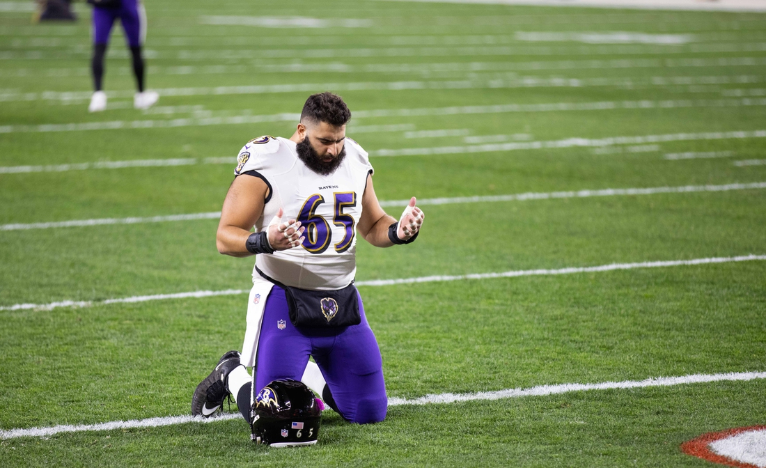 Dec 14, 2020; Cleveland, Ohio, USA; Baltimore Ravens offensive guard Patrick Mekari (65) kneels in the end zone before the game against the Cleveland Browns at FirstEnergy Stadium. Mandatory Credit: Scott Galvin-USA TODAY Sports