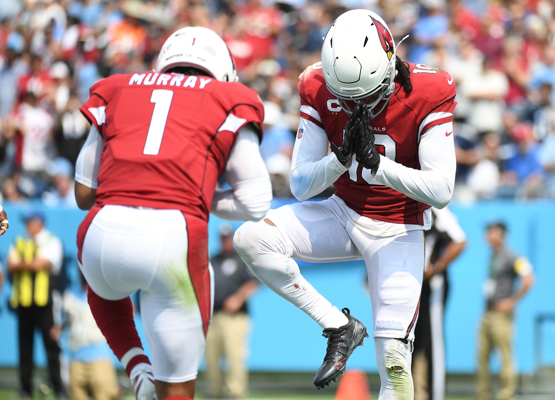 Sep 12, 2021; Nashville, Tennessee, USA; Arizona Cardinals quarterback Kyler Murray (1) celebrates with Arizona Cardinals wide receiver DeAndre Hopkins (10) after a touchdown during the first half against the Tennessee Titans at Nissan Stadium. Mandatory Credit: Christopher Hanewinckel-USA TODAY Sports