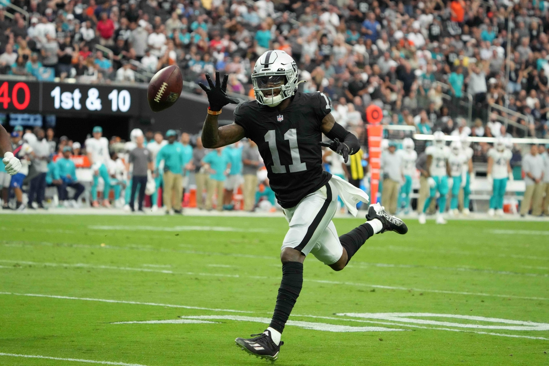 Sep 26, 2021; Paradise, Nevada, USA; Las Vegas Raiders wide receiver Henry Ruggs III (11) attempts to catch a pass in the second half against the Miami Dolphins at Allegiant Stadium.The Raiders defeated the Dolphins 31-28 in overtime. Mandatory Credit: Kirby Lee-USA TODAY Sports