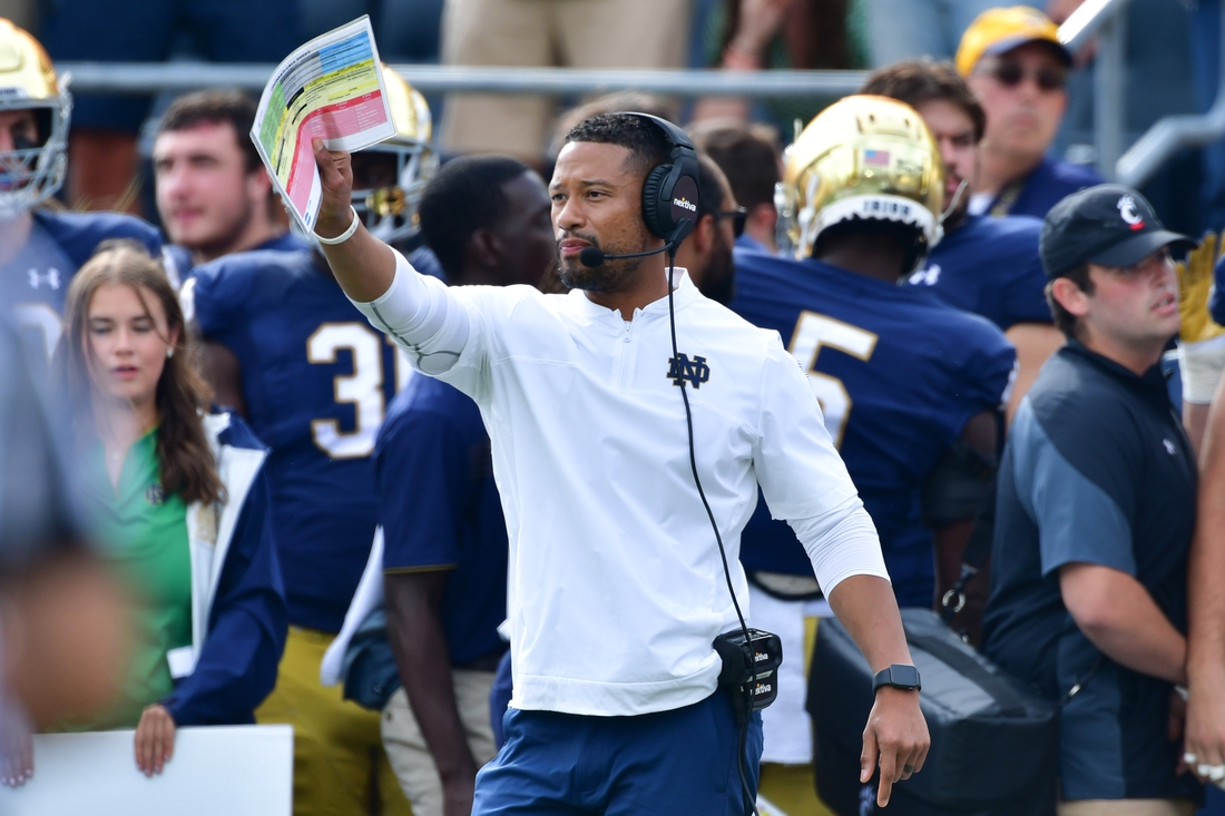 Oct 2, 2021; South Bend, Indiana, USA; Notre Dame Fighting Irish Defensive Coordinator Marcus Freeman signals to his players in the second quarter against the Cincinnati Bearcats at Notre Dame Stadium. Mandatory Credit: Matt Cashore-USA TODAY Sports