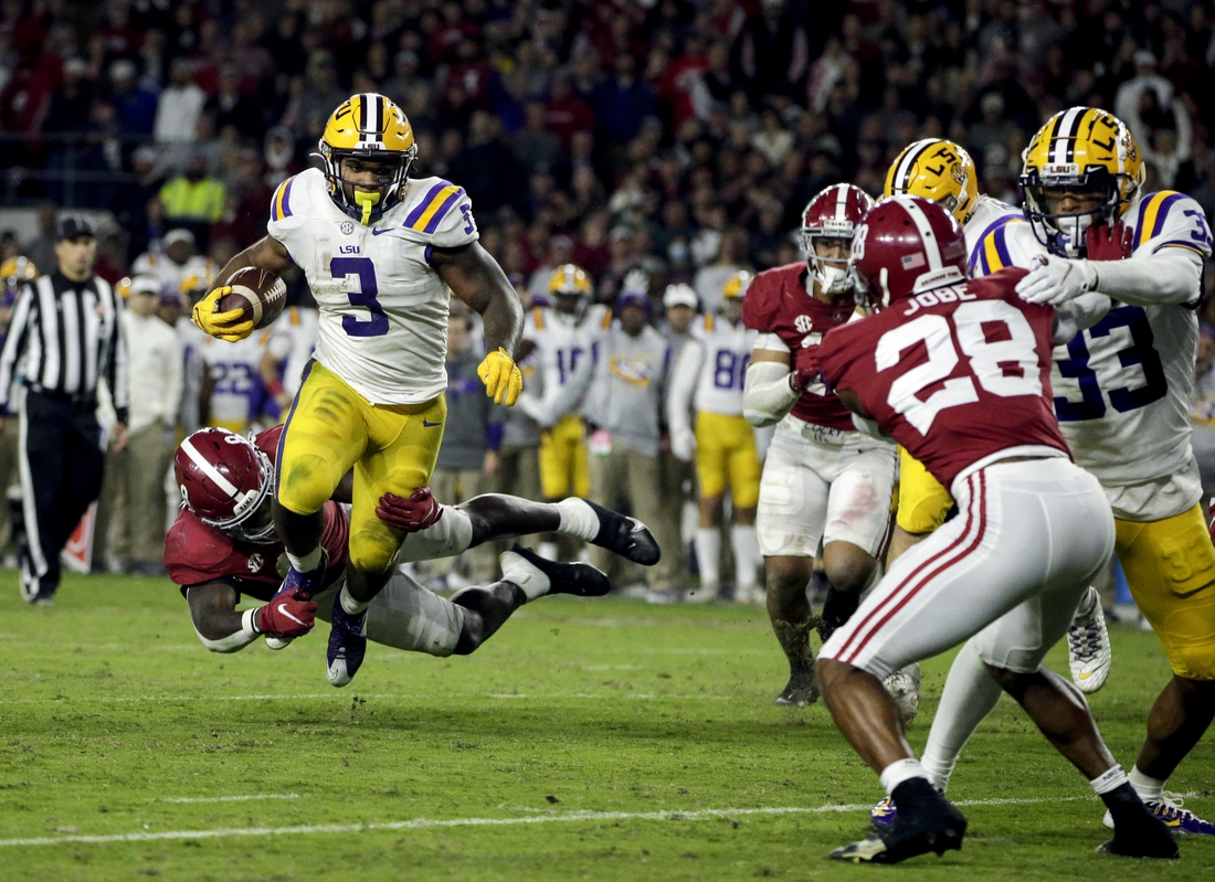 Nov 6, 2021; Tuscaloosa, Alabama, USA; LSU Tigers running back Tyrion Davis-Price (3) is tackled for a loss by Alabama Crimson Tide linebacker Christian Harris (8) during the second half at Bryant-Denny Stadium. Mandatory Credit: Butch Dill-USA TODAY Sports