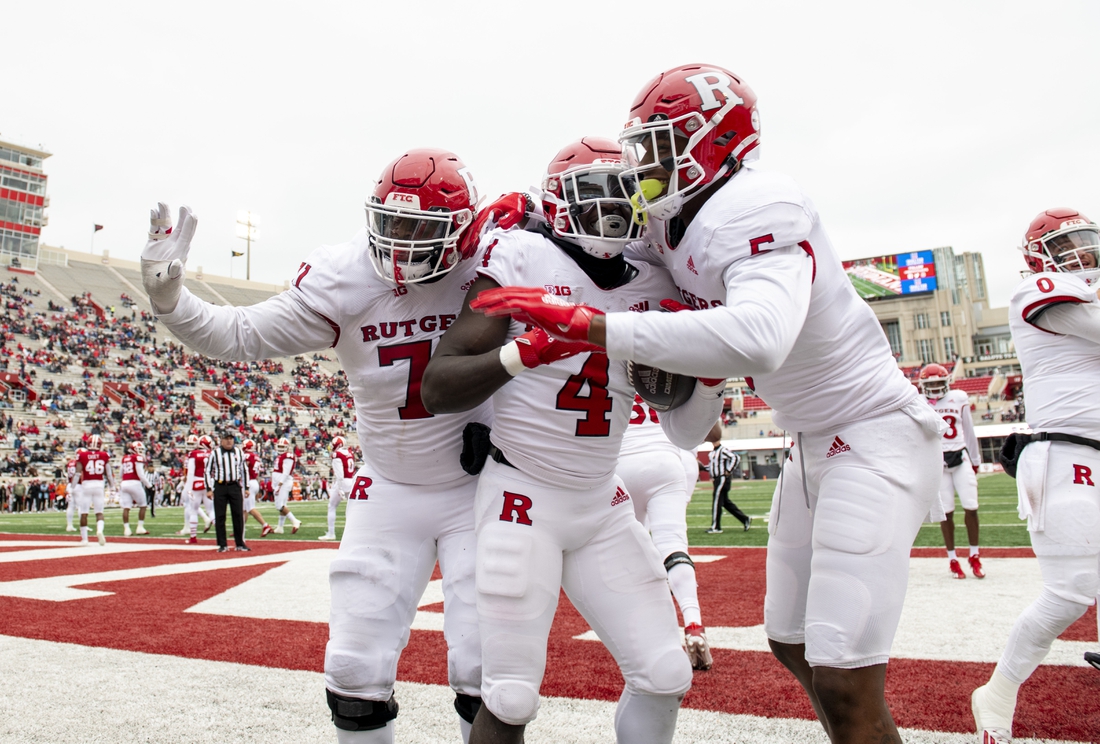 Nov 13, 2021; Bloomington, Indiana, USA; The Rutgers Scarlet Knights celebrate a touchdown by running back Aaron Young (4) during the second half against the Indiana Hoosiers at Memorial Stadium. The Scarlet Knights won 38-3.  Mandatory Credit: Marc Lebryk-USA TODAY Sports