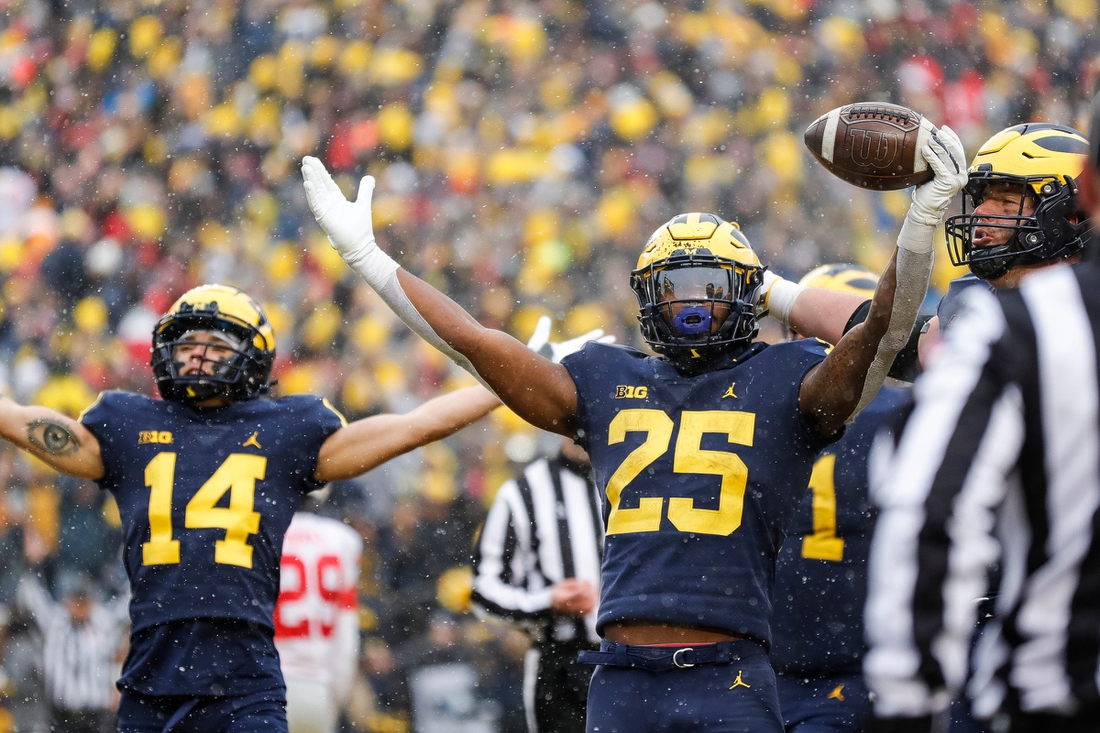 Michigan running back Hassan Haskins (25) celebrates  scoring a touchdown against Ohio State during the second half at Michigan Stadium in Ann Arbor on Saturday, Nov. 27, 2021.

michigan happy