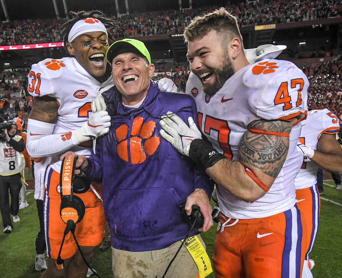 Clemson defensive coordinator Brent Venables is dunked with sports drink by linebacker James Skalski (47) and linebacker Baylon Spector (10) with corner back Mario Goodrich (31) after the game at Williams Brice Stadium in Columbia, South Carolina Saturday, November 27, 2021.  Clemson won 30-0.

Clemson U Of Sc Football In Columbia