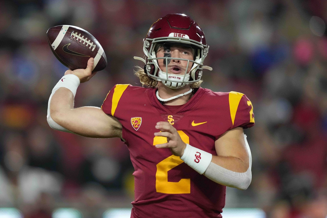 Nov 27, 2021; Los Angeles, California, USA; Southern California Trojans quarterback Jaxson Dart (2) throws the ball against the BYU Cougars in the first half at United Airlines Field at Los Angeles Memorial Coliseum. Mandatory Credit: Kirby Lee-USA TODAY Sports
