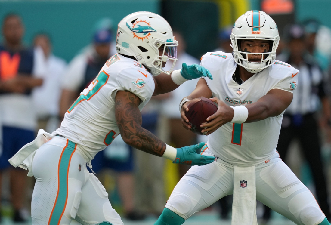 Nov 28, 2021; Miami Gardens, Florida, USA; Miami Dolphins quarterback Tua Tagovailoa (1) hands the ball to running back Myles Gaskin (37) during the first against the Carolina Panthers at Hard Rock Stadium. Mandatory Credit: Jasen Vinlove-USA TODAY Sports