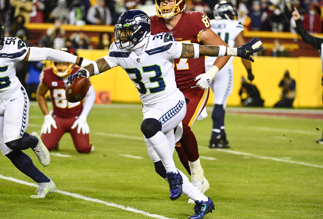 Nov 29, 2021; Landover, Maryland, USA; Seattle Seahawks safety Jamal Adams (33) reacts after recording an interception against the Washington Football Team during the first half at FedExField. Mandatory Credit: Brad Mills-USA TODAY Sports