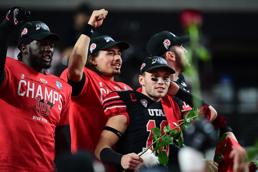 December 3, 2021; Las Vegas, NV, USA; Utah Utes linebacker Devin Lloyd (0) quarterback Cameron Rising (7) and wide receiver Britain Covey (18) celebrate the victory against the Oregon Ducks in the 2021 Pac-12 Championship Game at Allegiant Stadium. Mandatory Credit: Gary A. Vasquez-USA TODAY Sports