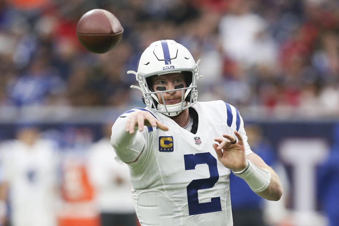 Dec 5, 2021; Houston, Texas, USA; Indianapolis Colts quarterback Carson Wentz (2) completes a pass against the Houston Texans in the second half at NRG Stadium. Indianapolis Colts won 31 to 0 .Mandatory Credit: Thomas Shea-USA TODAY Sports
