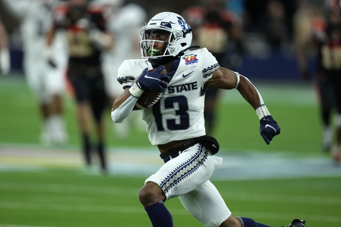 Dec 18, 2021; Inglewood, CA, USA; Utah State Aggies wide receiver Deven Thompkins (13) scores on a 62-yard touchdown reception against the Oregon State Beavers in the first half of the 2021 LA Bowl at SoFi Stadium. Mandatory Credit: Kirby Lee-USA TODAY Sports