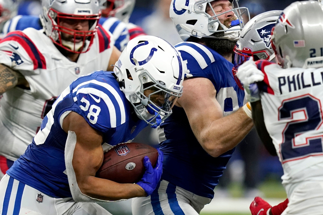 Indianapolis Colts running back Jonathan Taylor (28) rushes the ball Saturday, Dec. 18, 2021, during a game against the New England Patriots at Lucas Oil Stadium in Indianapolis.