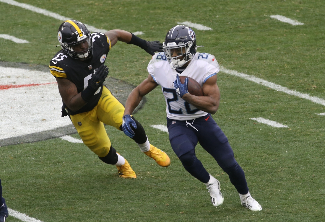 Dec 19, 2021; Pittsburgh, Pennsylvania, USA;  Tennessee Titans running back Jeremy McNichols (28) runs the ball against Pittsburgh Steelers inside linebacker Devin Bush (55) during the second quarter at Heinz Field. Mandatory Credit: Charles LeClaire-USA TODAY Sports