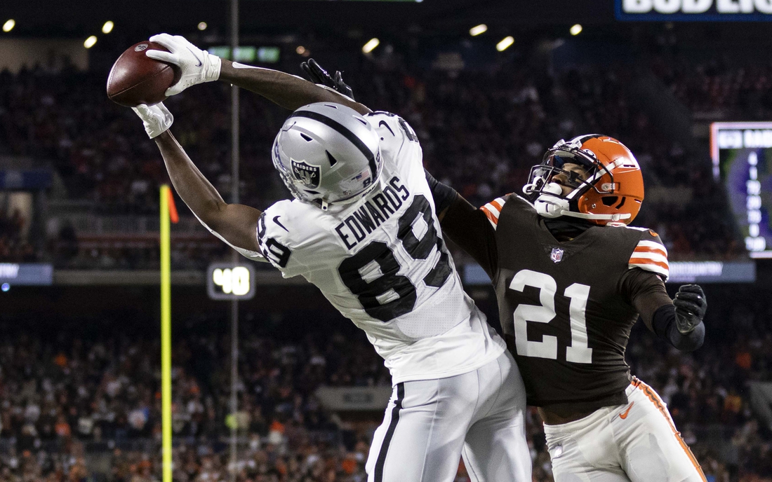 Dec 20, 2021; Cleveland, Ohio, USA; Las Vegas Raiders wide receiver Bryan Edwards (89) makes a touchdown reception in the end zone against Cleveland Browns cornerback Denzel Ward (21) during the first quarter at FirstEnergy Stadium. Mandatory Credit: Scott Galvin-USA TODAY Sports