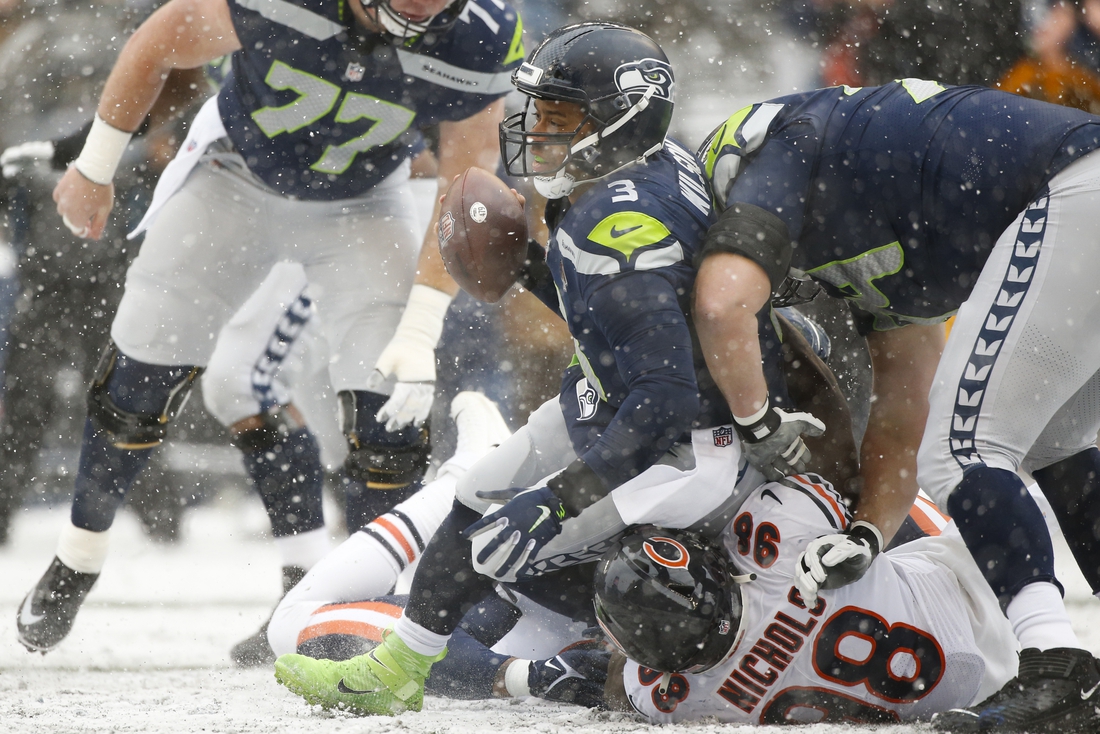Dec 26, 2021; Seattle, Washington, USA; Seattle Seahawks quarterback Russell Wilson (3) is sacked by Chicago Bears defensive end Bilal Nichols (98) during the first quarter at Lumen Field. Mandatory Credit: Joe Nicholson-USA TODAY Sports