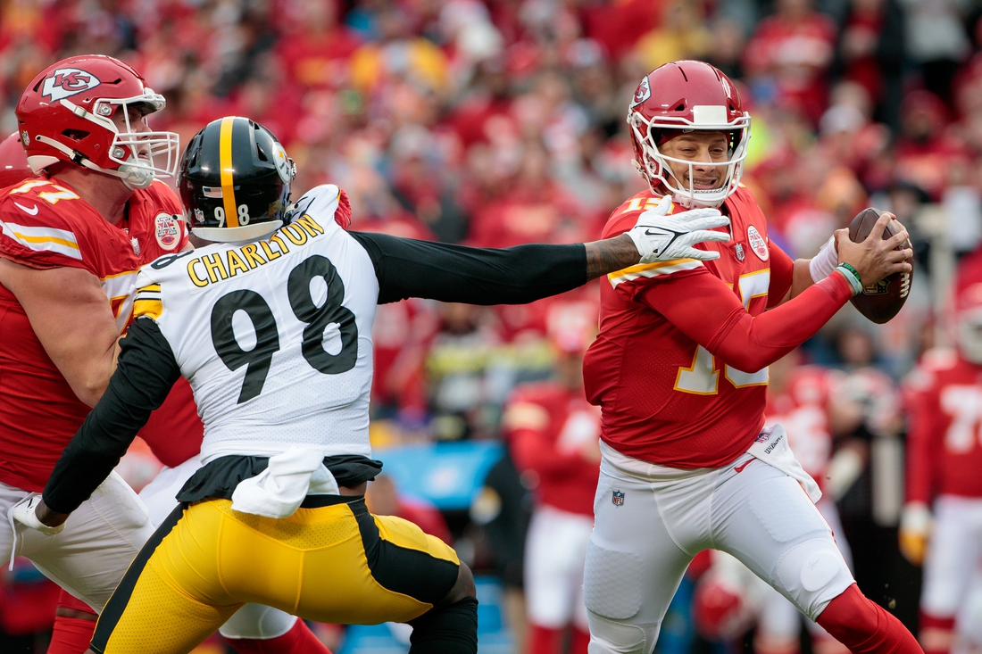 Dec 26, 2021; Kansas City, Missouri, USA; Pittsburgh Steelers defensive end Taco Charlton (98) reaches for Kansas City Chiefs quarterback Patrick Mahomes (15) as he scrambles in the back field during the first quarter at GEHA Field at Arrowhead Stadium. Mandatory Credit: William Purnell-USA TODAY Sports