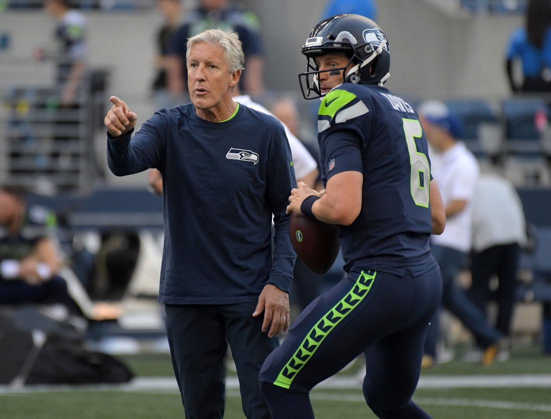 Aug 30, 2018; Seattle, WA, USA; Seattle Seahawks head coach Pete Carroll (left) talks with quarterback Austin Davis (6) against the Oakland Raiders during a preseason game at CenturyLink Field. The Raiders defeated the Seahawks 30-19. Mandatory Credit: Kirby Lee-USA TODAY Sports