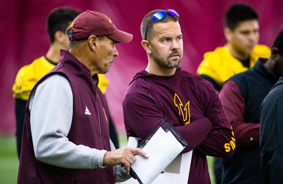 Arizona State University head football coach Herm Edwards speaks with newly hired offensive coordinator Zak Hill during practice at the Verde Dickey Dome on campus in Tempe, Tuesday, December 17, 2019.

Asu Football