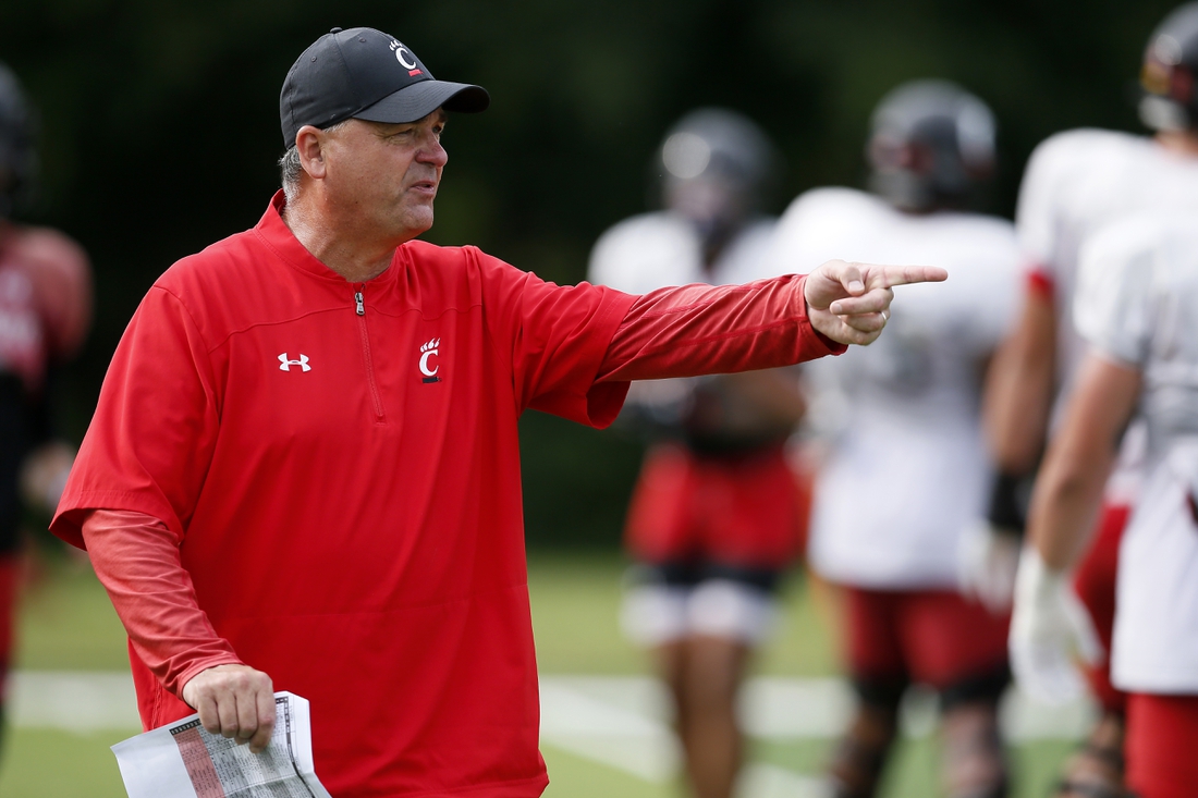Aug 9, 2021; West Harrison, Indiana, USA; Cincinnati Bearcats offensive coordinator Mike Denbrock directs a drill during practice at the Higher Ground training facility. Mandatory Credit: Sam Greene/The Cincinnati Enquirer via USA TODAY NETWORK