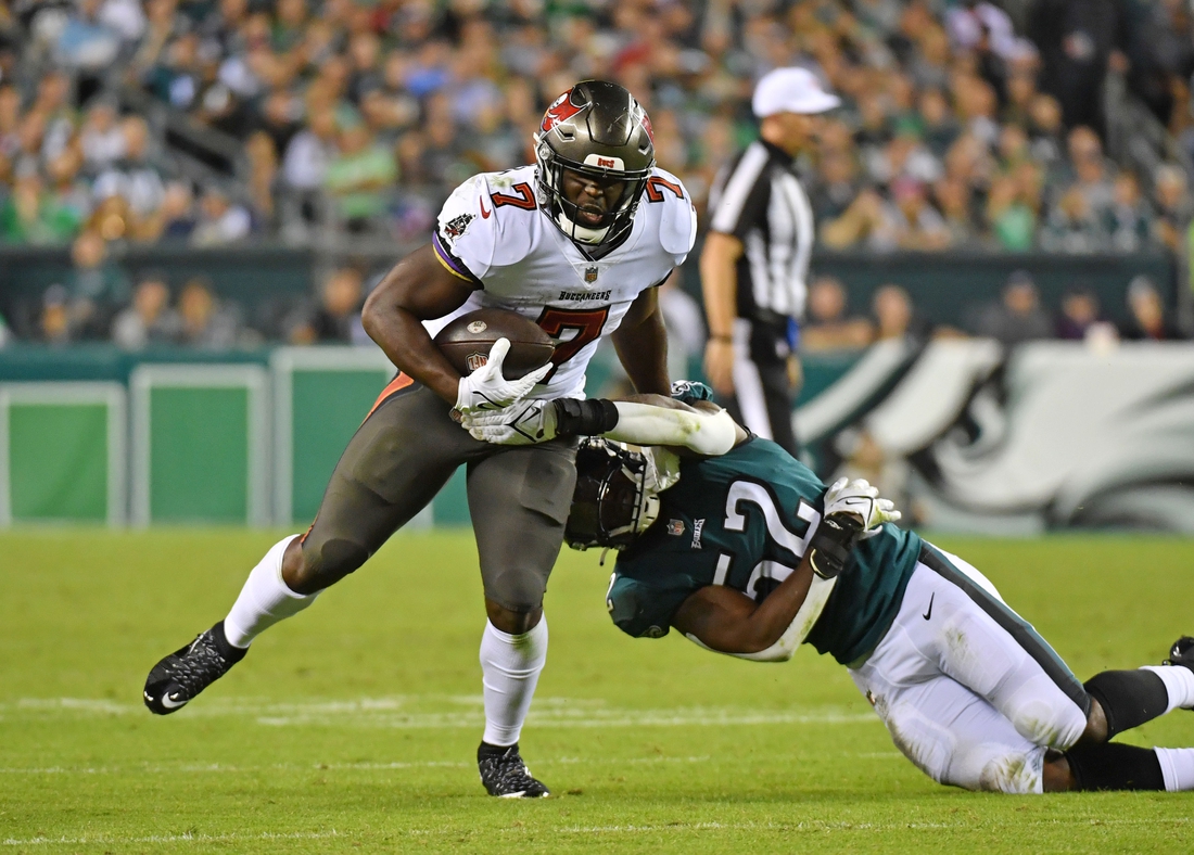 Oct 14, 2021; Philadelphia, Pennsylvania, USA;  Tampa Bay Buccaneers running back Leonard Fournette (7) pushes away from Philadelphia Eagles linebacker Davion Taylor (52) during the second quarter at Lincoln Financial Field. Mandatory Credit: Eric Hartline-USA TODAY Sports