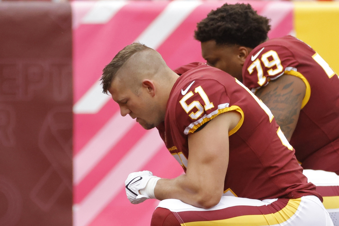 Oct 10, 2021; Landover, Maryland, USA; Washington Football Team outside linebacker David Mayo (51) and Washington Football Team guard Ereck Flowers (79) kneel in the end zone prior to the Washington Football Team's game against the New Orleans Saints at FedExField. Mandatory Credit: Geoff Burke-USA TODAY Sports