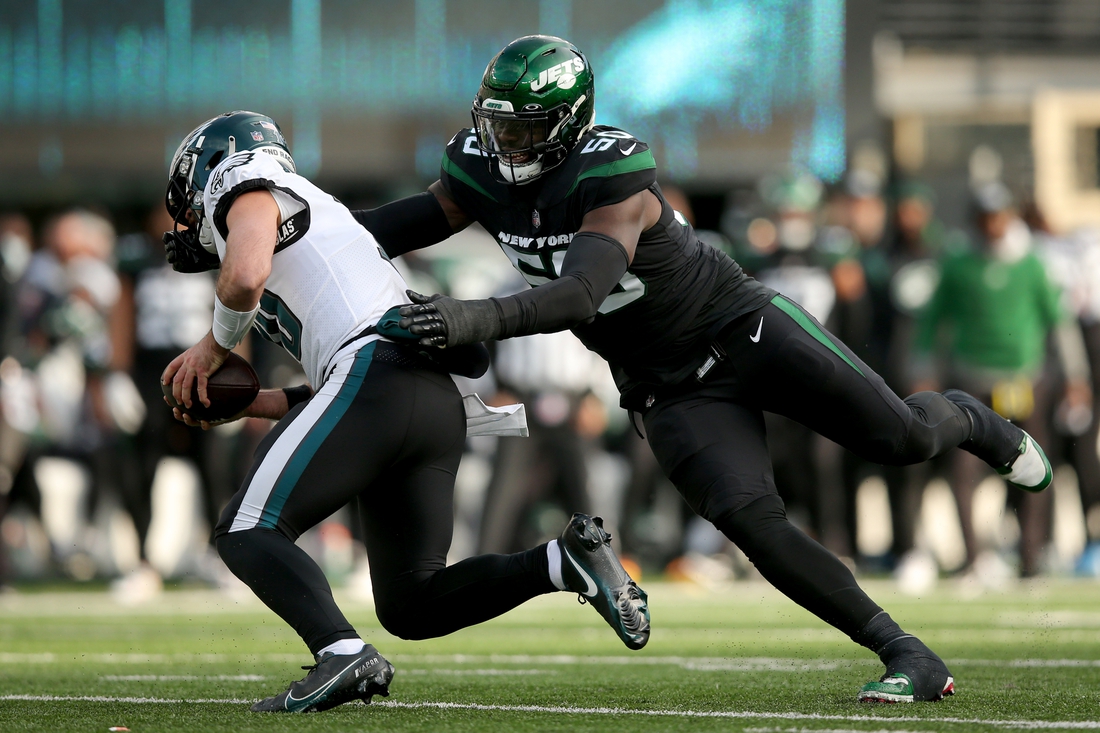 Dec 5, 2021; East Rutherford, New Jersey, USA; Philadelphia Eagles quarterback Gardner Minshew (10) is sacked by New York Jets defensive end Shaq Lawson (50) during the second quarter at MetLife Stadium. Lawson was called for a facemask penalty on the play. Mandatory Credit: Brad Penner-USA TODAY Sports