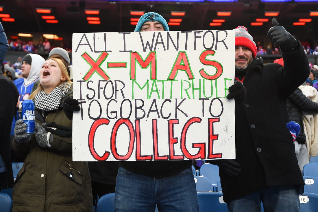 Dec 19, 2021; Orchard Park, New York, USA; Carolina Panthers fans hold a sign for Carolina Panthers head coach Matt Rhule (not pictured) against the Buffalo Bills during the second half at Highmark Stadium. Mandatory Credit: Rich Barnes-USA TODAY Sports