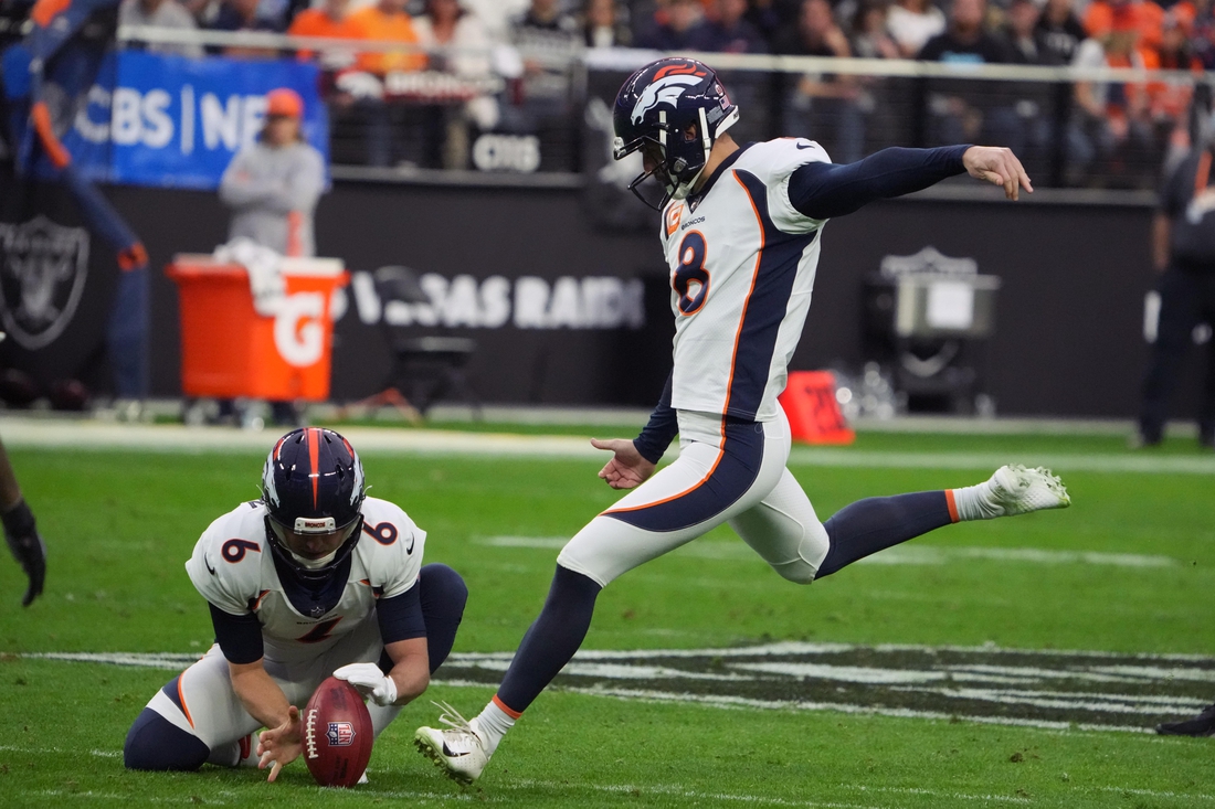 Dec 26, 2021; Paradise, Nevada, USA; Denver Broncos kicker Brandon McManus (8) attempts a field goal out of the hold of punter Sam Martin (6) against the Las Vegas Raiders in the first half at Allegiant Stadium. Mandatory Credit: Kirby Lee-USA TODAY Sports
