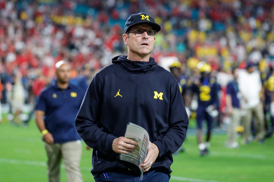 Michigan head coach Jim Harbaugh walks off the field after the Wolverines' 34-11 loss to the Georgia Bulldogs in the Orange Bowl.

Syndication Detroit Free Press