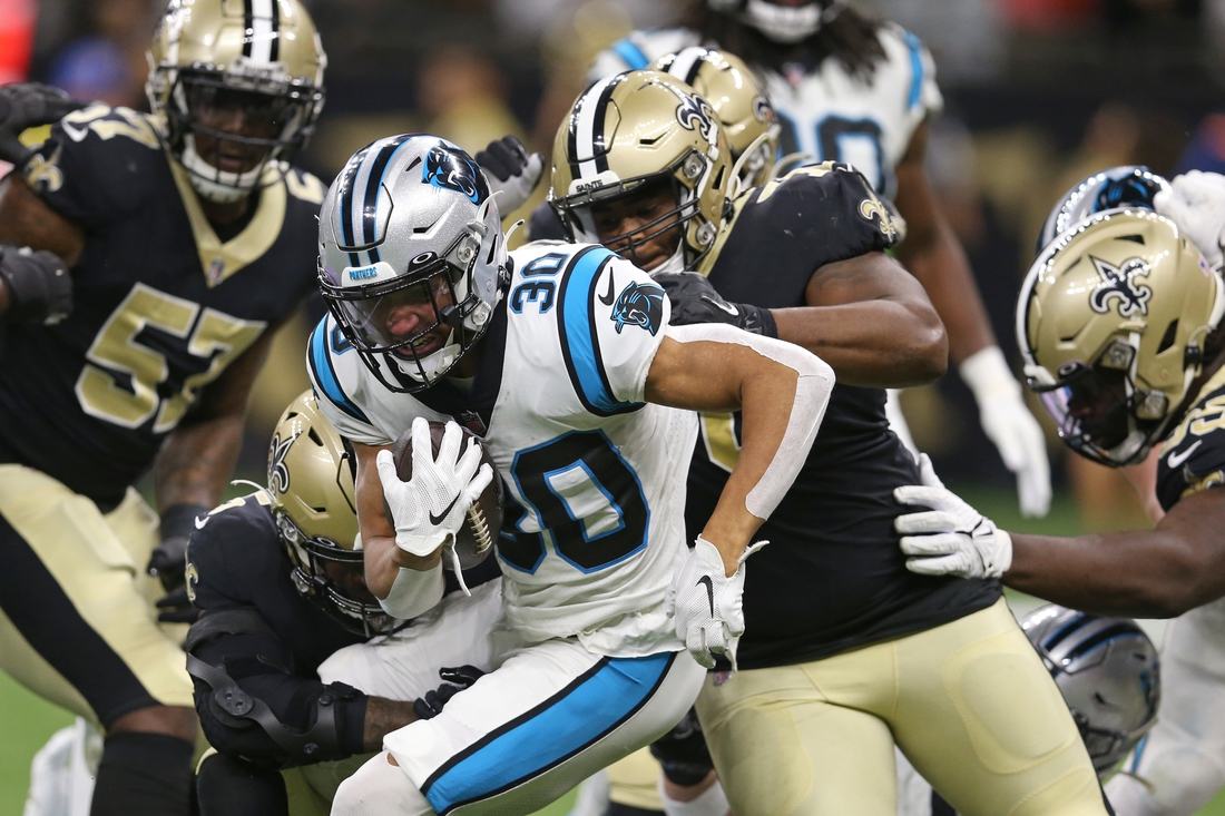 Jan 2, 2022; New Orleans, Louisiana, USA; Carolina Panthers running back Chuba Hubbard (30) is tackled by several New Orleans Saints defenders in the first quarter at the Caesars Superdome. Mandatory Credit: Chuck Cook-USA TODAY Sports