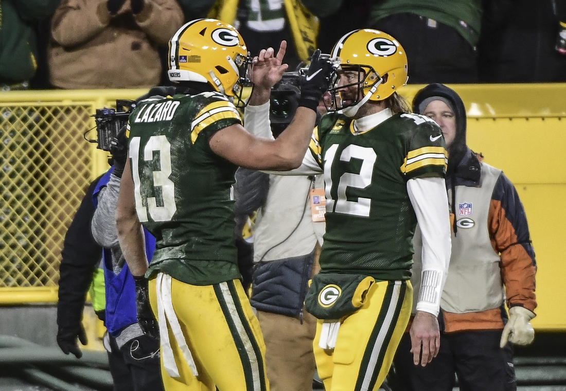 Jan 2, 2022; Green Bay, Wisconsin, USA; Green Bay Packers quarterback Aaron Rodgers (12) celebrates with wide receiver Allen Lazard (13) after a touchdown in the second quarter against the Minnesota Vikings at Lambeau Field. Mandatory Credit: Benny Sieu-USA TODAY Sports