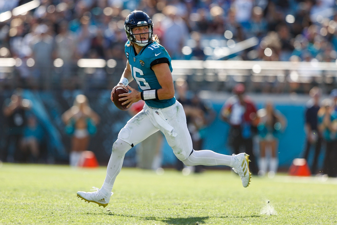 Jan 9, 2022; Jacksonville, Florida, USA;  Jacksonville Jaguars quarterback Trevor Lawrence (16) moves out to pass n the second half against the Indianapolis Colts at TIAA Bank Field. Mandatory Credit: Nathan Ray Seebeck-USA TODAY Sports