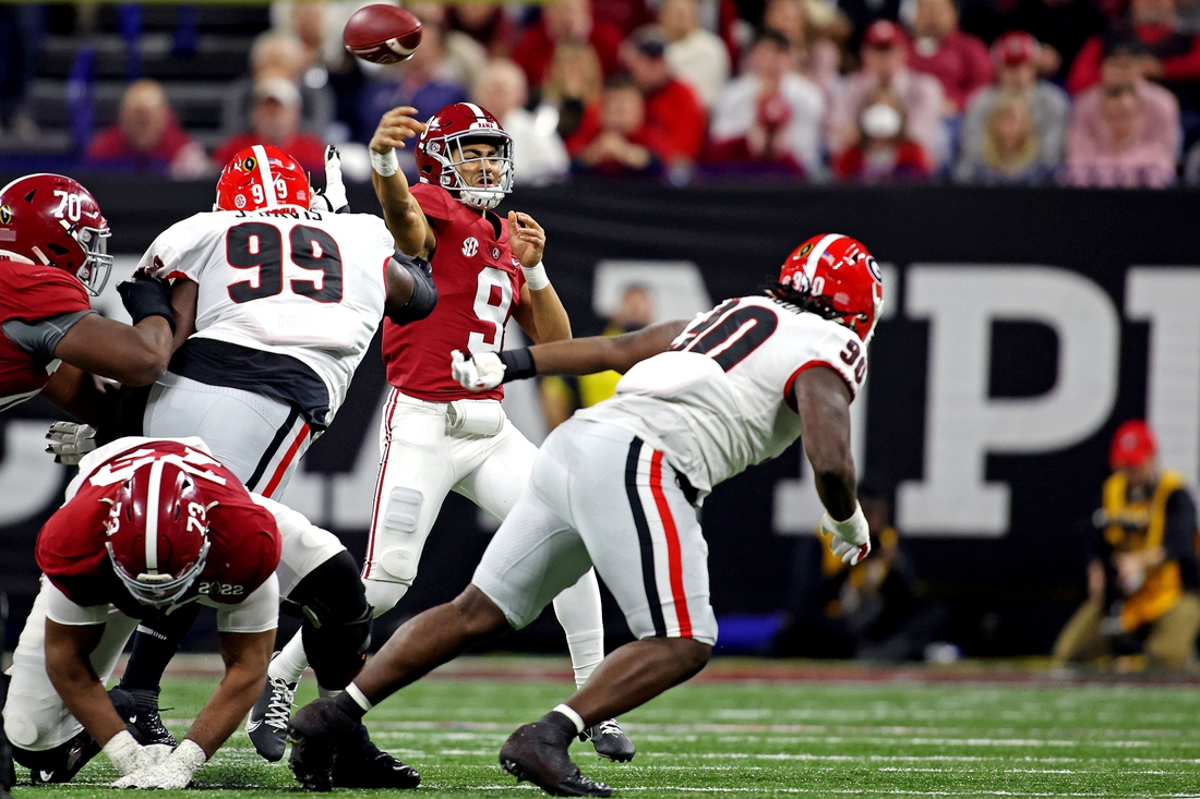 Jan 10, 2022; Indianapolis, IN, USA; Alabama Crimson Tide quarterback Bryce Young (9) throws a pass against Georgia Bulldogs defensive lineman Jordan Davis (99) during the second quarter in the 2022 CFP college football national championship game at Lucas Oil Stadium. Mandatory Credit: Trevor Ruszkowski-USA TODAY Sports