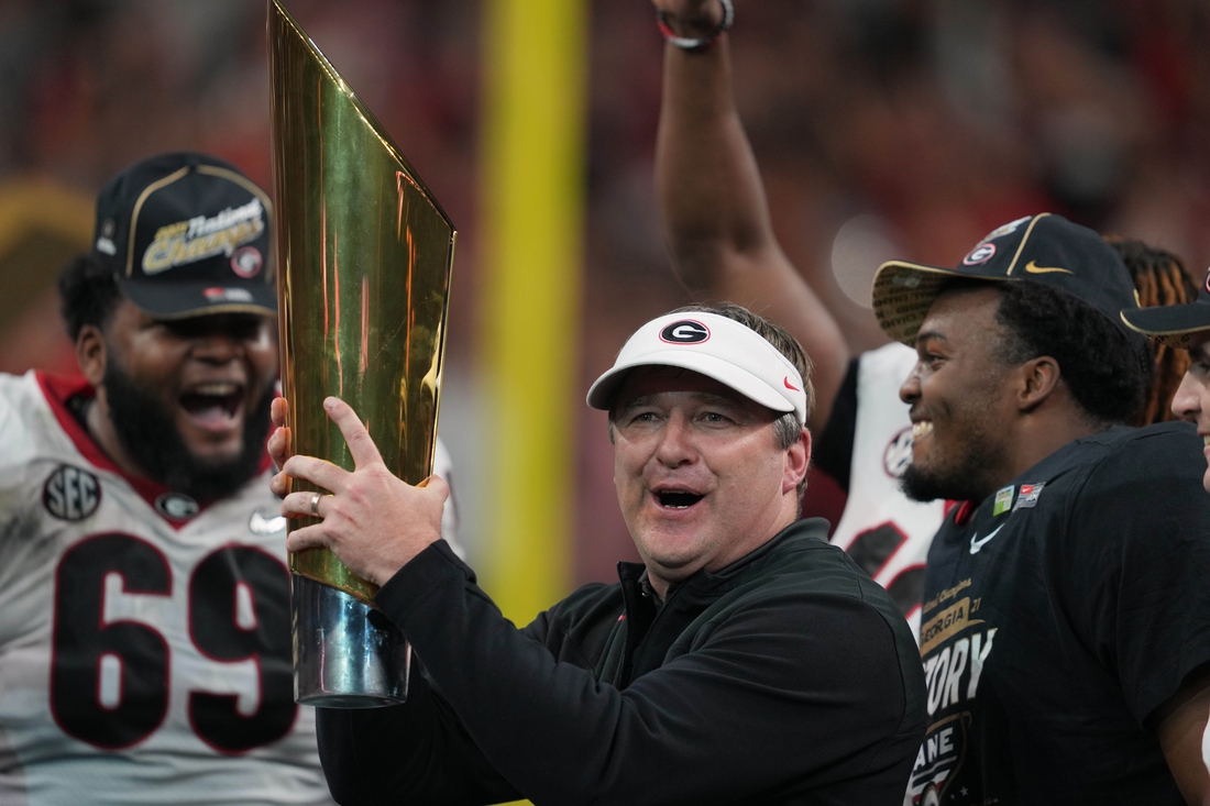Jan 10, 2022; Indianapolis, IN, USA; Georgia Bulldogs head coach Kirby Smart holds the National Championship trophy after defeating the Alabama Crimson Tide in the 2022 CFP college football national championship game at Lucas Oil Stadium. Mandatory Credit: Kirby Lee-USA TODAY Sports
