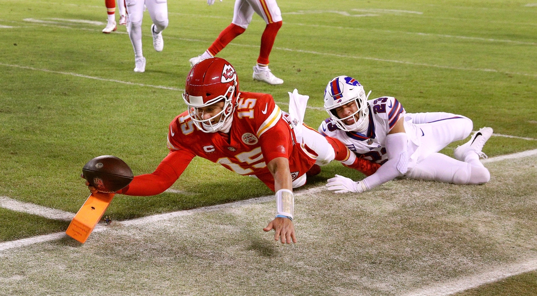 Chiefs quarterback Patrick Mahomes dives into the end zone for an 8-yard touchdown against the Bills Micah Hyde. The Chiefs won 42-36 in overtime.Syndication Democrat And Chronicle