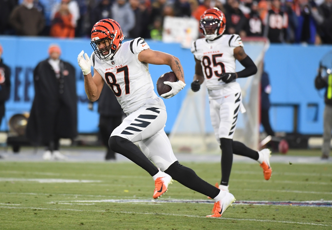 Jan 22, 2022; Nashville, Tennessee, USA; Cincinnati Bengals tight end C.J. Uzomah (87) runs after a reception against the Tennessee Titans during a AFC Divisional playoff football game at Nissan Stadium. Mandatory Credit: Christopher Hanewinckel-USA TODAY Sports