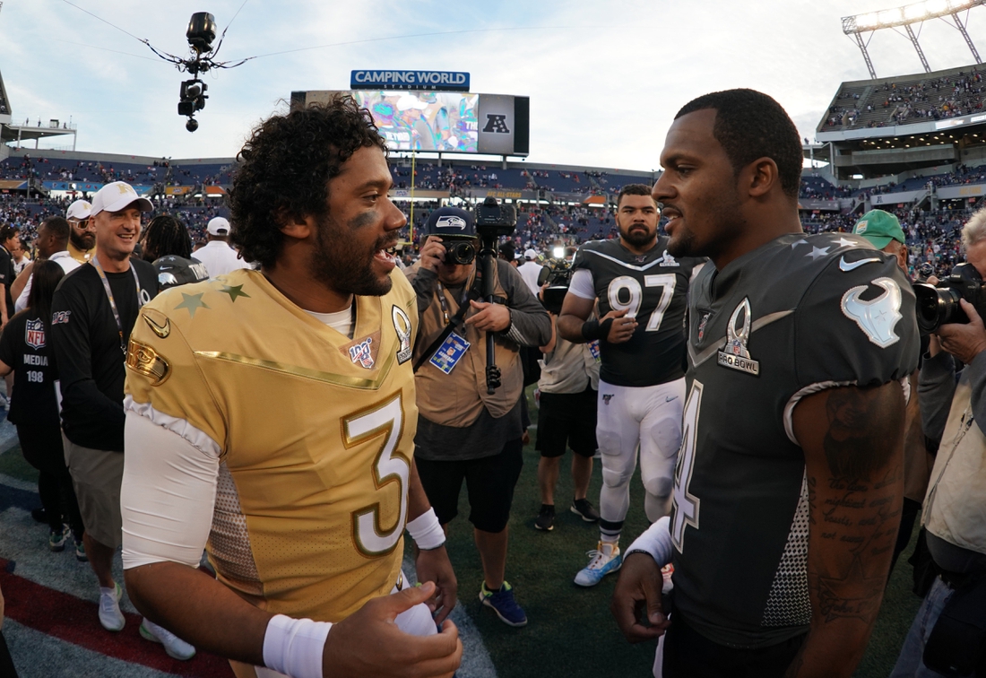 Jan 26, 2020; Orlando, Florida, USA;  NFC quarterback Russell Wilson of the Seattle Seahawks (3) and AFC quarterback Deshaun Watson of the Houston Texans (4) talk after the 2020 NFL Pro Bowl at Camping World Stadium. The AFC defeated the NFC 38-33.  Mandatory Credit: Kirby Lee-USA TODAY Sports