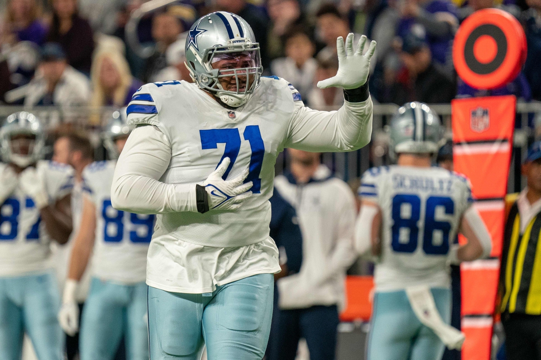 Oct 31, 2021; Minneapolis, Minnesota, USA; Dallas Cowboys offensive tackle La'el Collins (71) indicates he is an eligible receiver entering the game in the third quarter against the Minnesota Vikings at U.S. Bank Stadium. Mandatory Credit: Matt Blewett-USA TODAY Sports