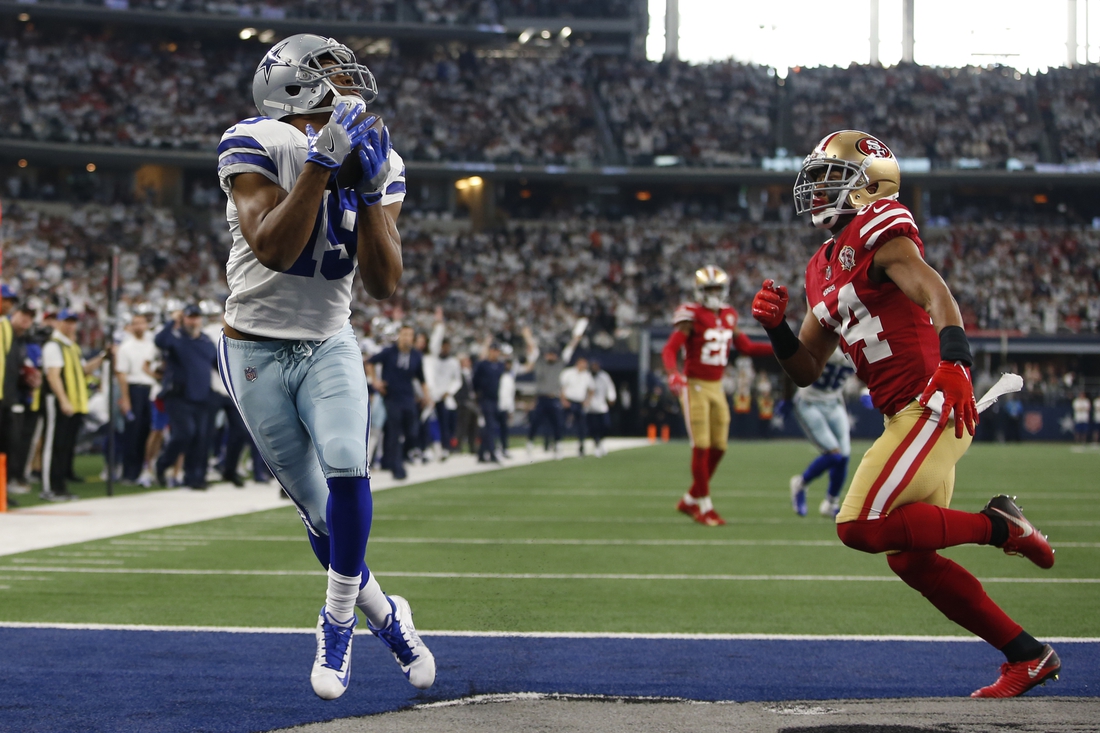 Jan 16, 2022; Arlington, Texas, USA; Dallas Cowboys wide receiver Amari Cooper (19) catches a touchdown pass in the second quarter against San Francisco 49ers defensive back K'Waun Williams (24) in a NFC Wild Card playoff football game at AT&T Stadium. Mandatory Credit: Tim Heitman-USA TODAY Sports